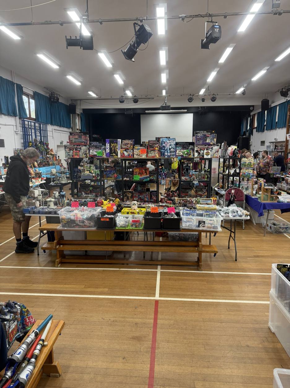 Reigate Toy Fair in full swing in the Reigate Priory School hall, with traders' tables of Transformers, Star Wars and Turtles toys