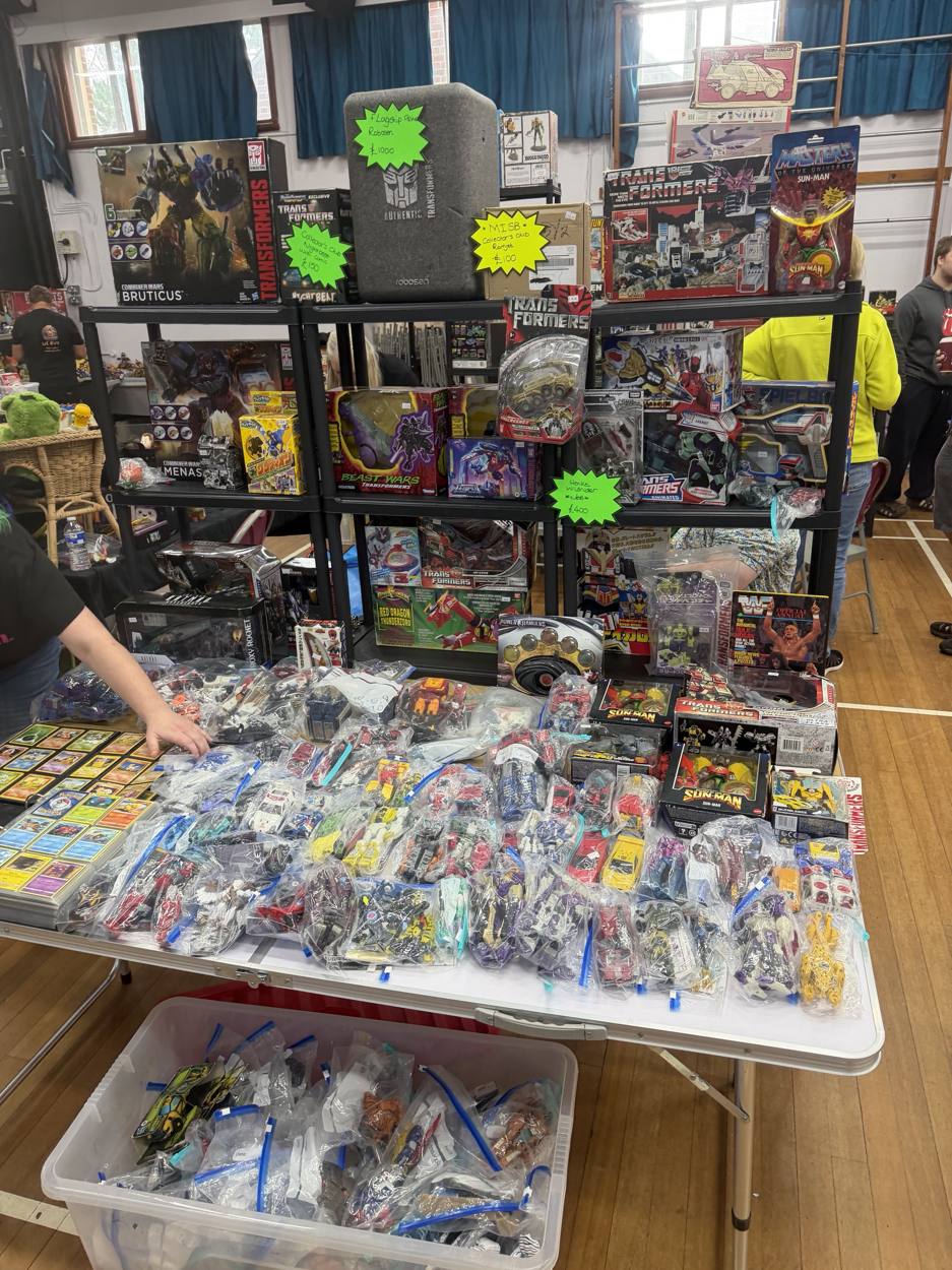 Transformers table with boxed figures and bagged loose Transformers